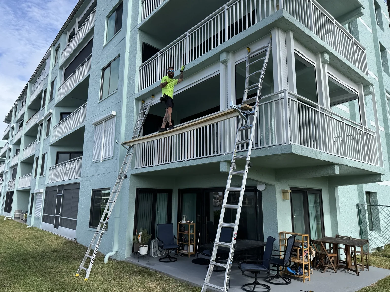 Second-floor balcony enclosure framing underway.