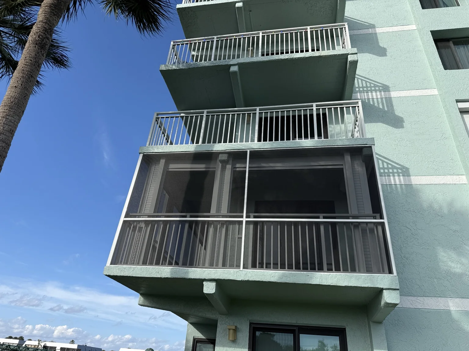 Completed second-floor screened balcony enclosure.