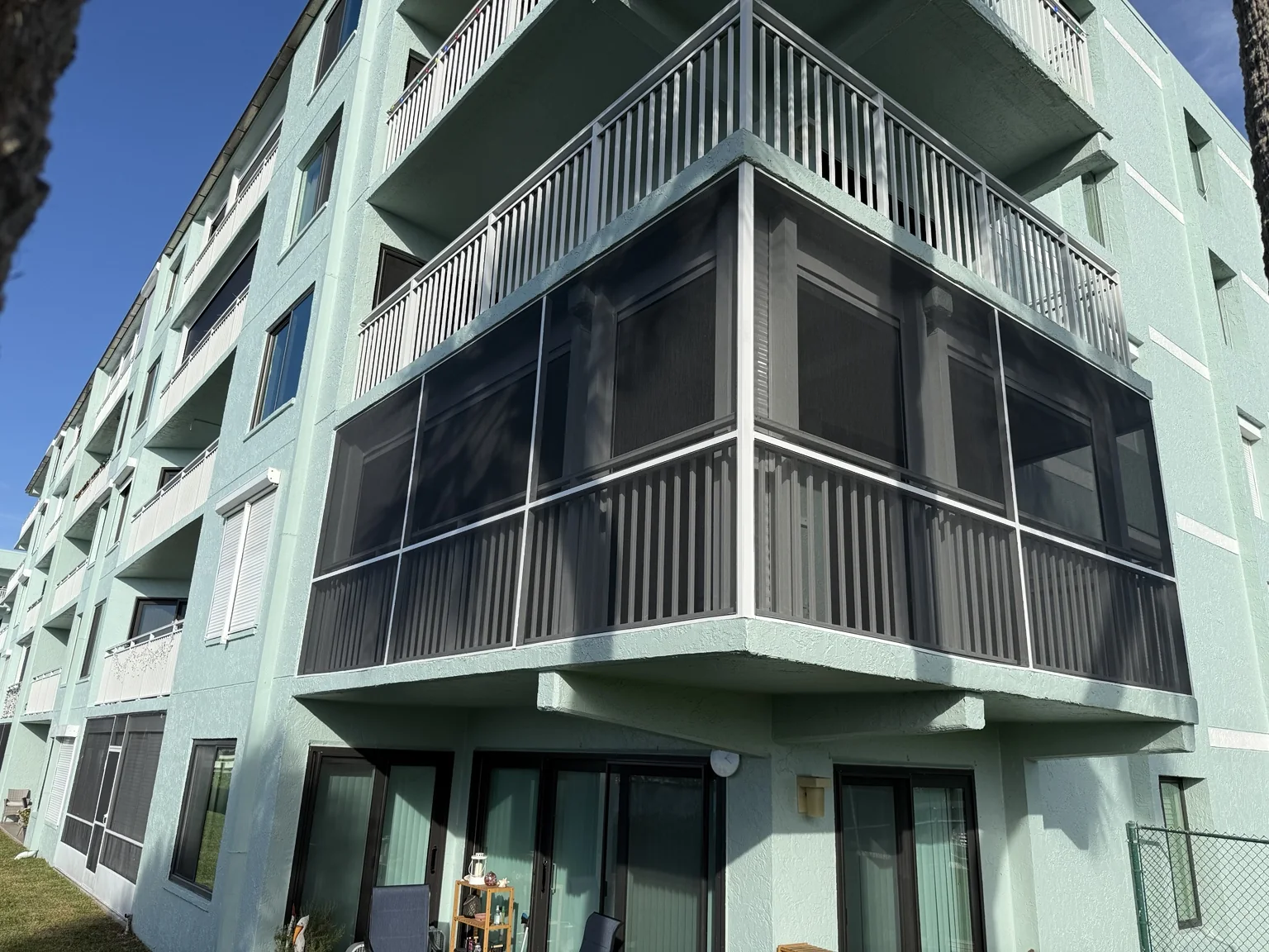 Completed second-floor balcony screen enclosure in Cocoa Beach, Florida