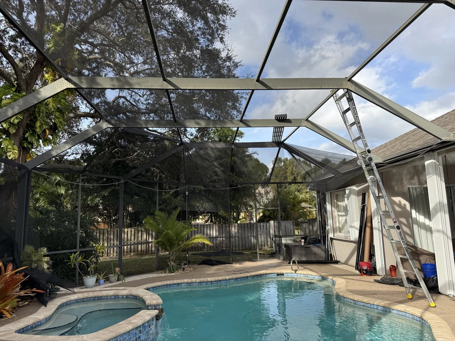 Existing pool enclosure stripped and prepared for a complete rescreen.
