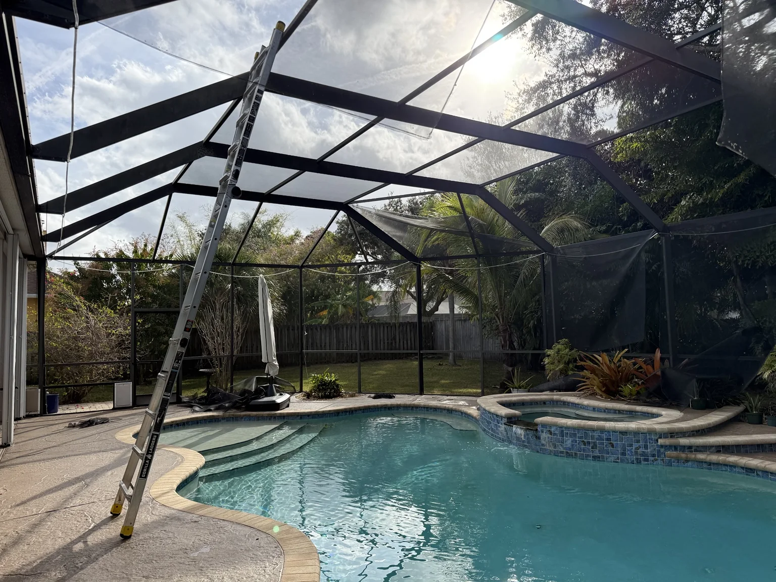 Full pool cage rescreen in progress.