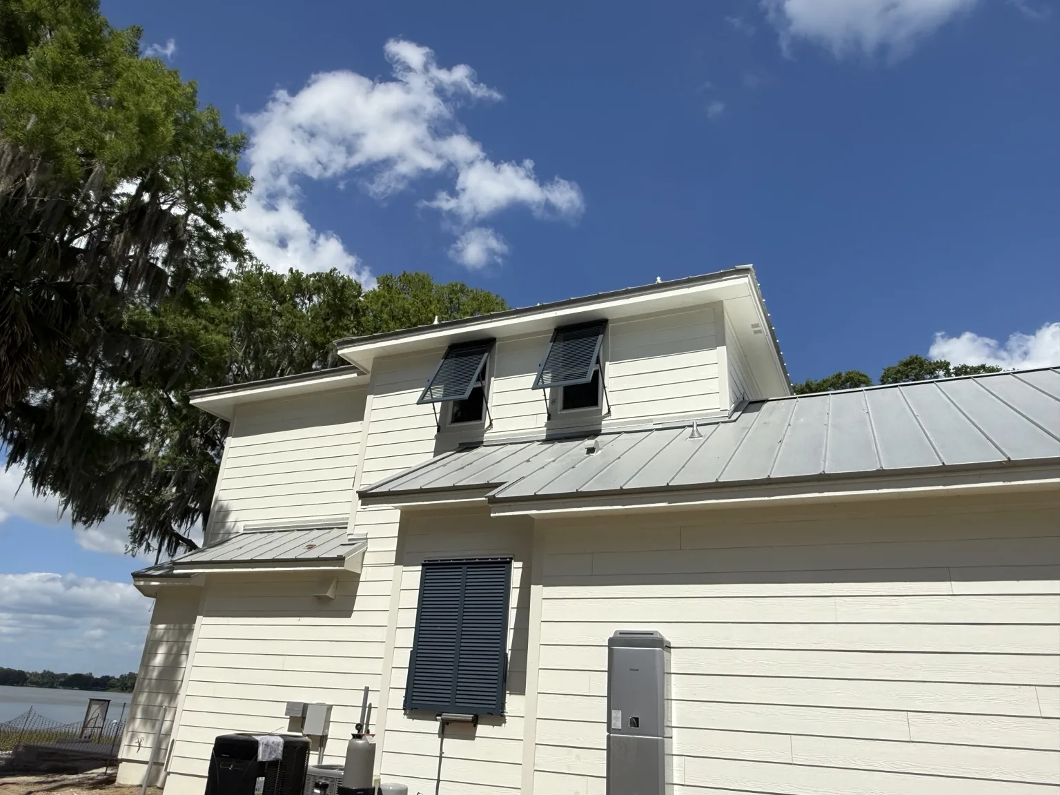 Bahama shutters integrated into a coastal-style home exterior.