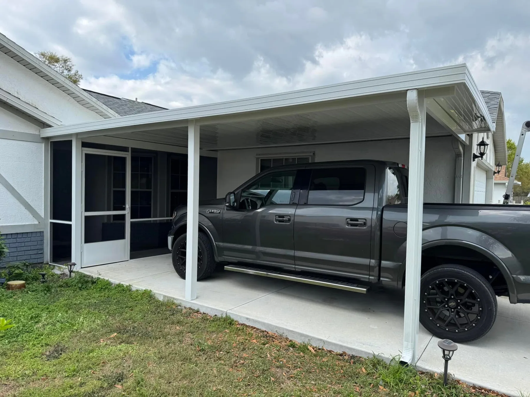 Custom carport designed around the home with covered parking and protected access.
