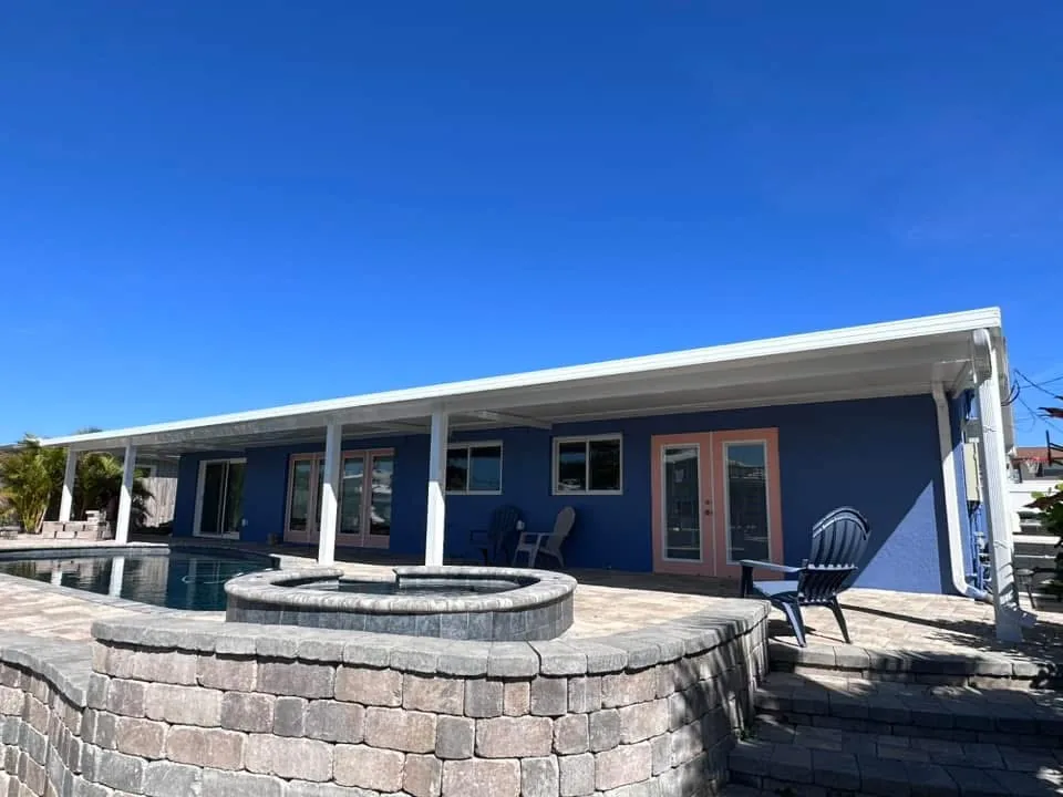 Wide-span patio cover creating shade and weather protection across an outdoor living area.