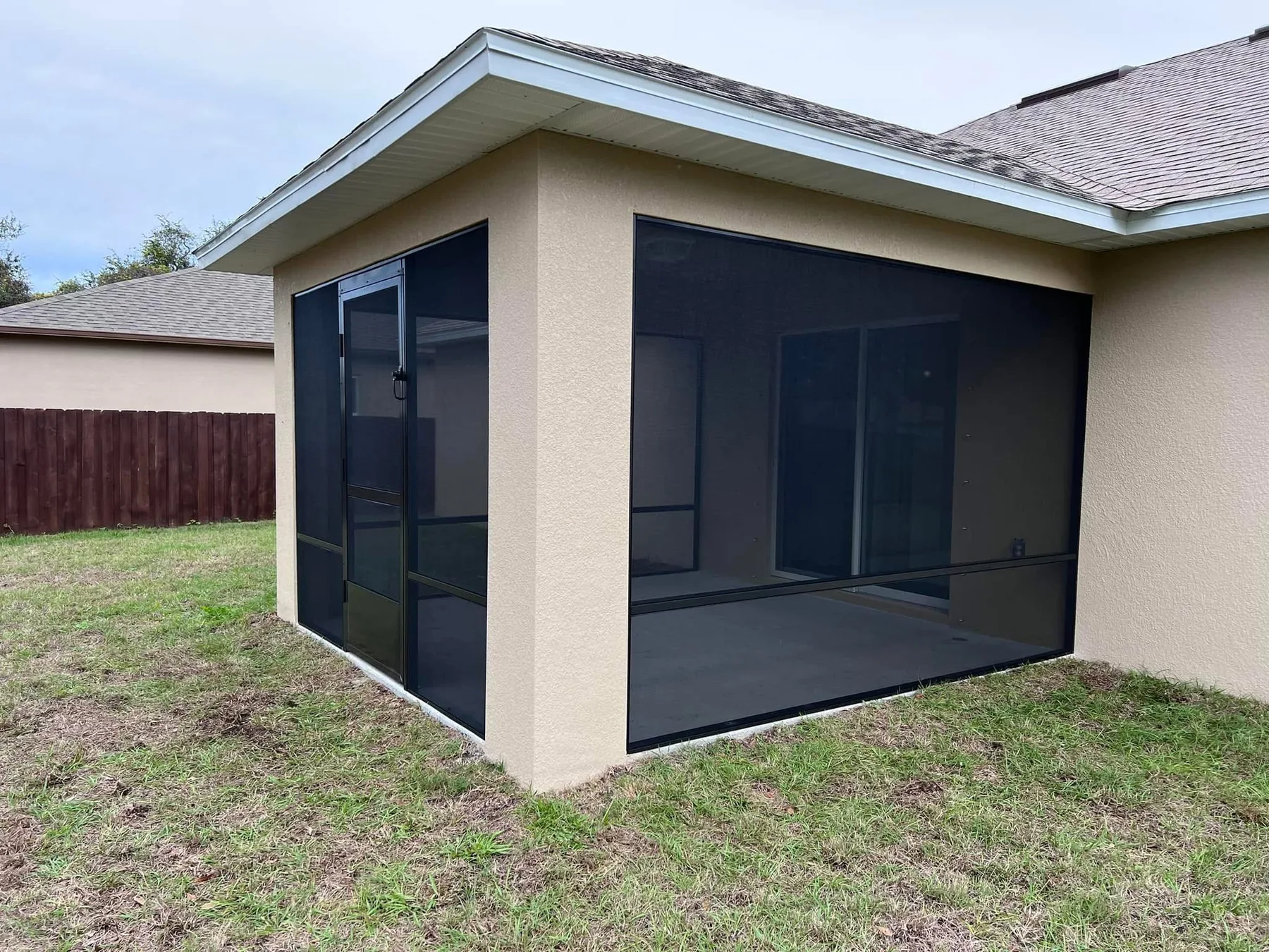 Screen walls and door built into the existing covered structure.