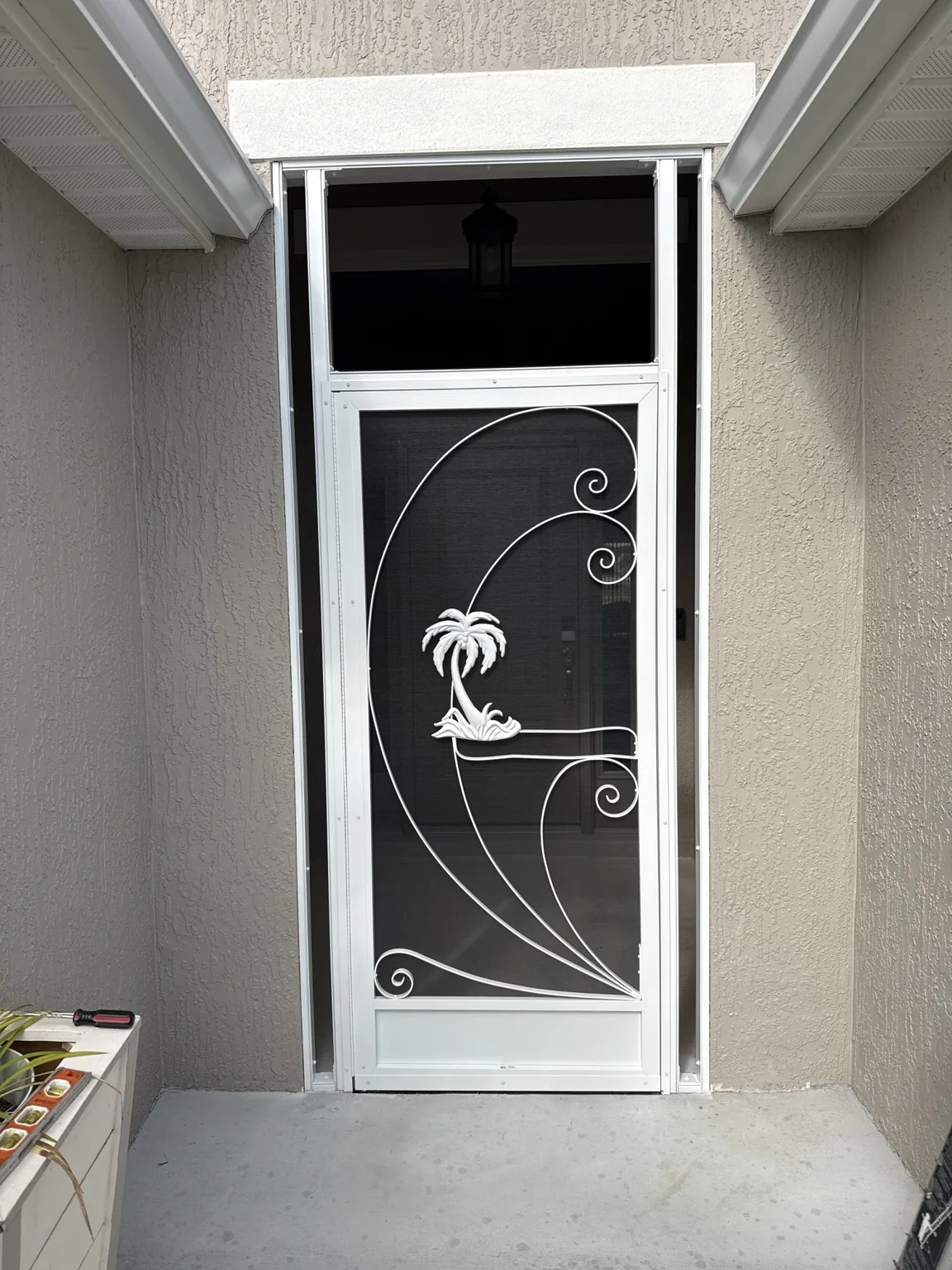 Decorative screened entry door with custom side and upper panels.