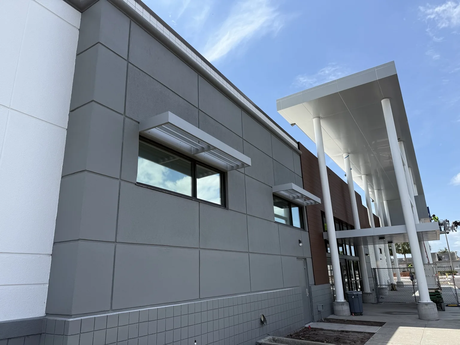 Custom structural awnings integrated into a modern commercial exterior.